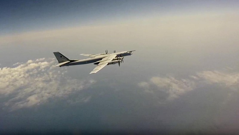 In this photo released by Russian Defense Ministry Press Service on Tuesday, May 24, 2022, A Tu-95 strategic bomber of the Russian air force flies on a mission at an undisclosed location. (Russian Defense Ministry Press Service via AP)