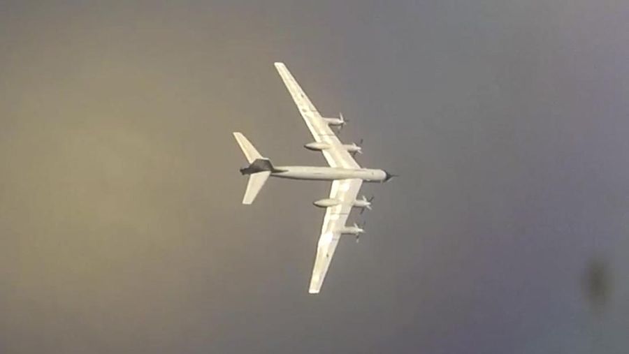 In this photo released by Russian Defense Ministry Press Service on Tuesday, May 24, 2022, A Tu-95 strategic bomber of the Russian air force flies on a mission at an undisclosed location. (Russian Defense Ministry Press Service via AP)