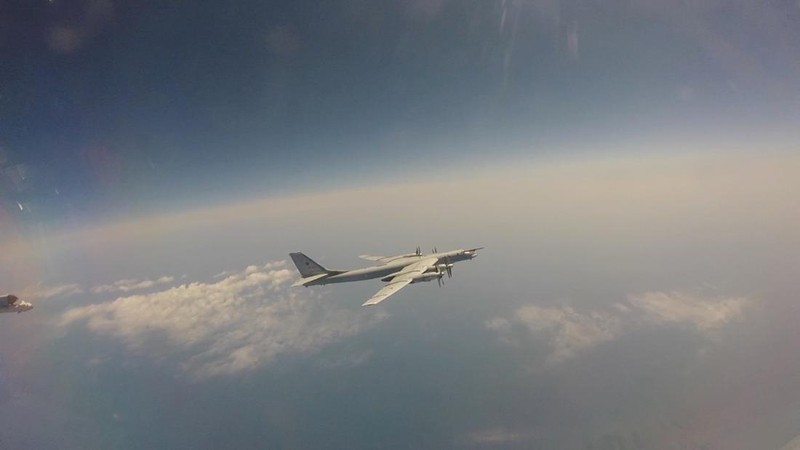 In this photo released by Russian Defense Ministry Press Service on Tuesday, May 24, 2022, A Tu-95 strategic bomber of the Russian air force flies on a mission at an undisclosed location. (Russian Defense Ministry Press Service via AP)