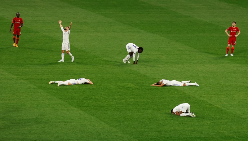 SOCCER-CHAMPIONS-LIV-MAD/REPORT Soccer Football - Champions League Final - Liverpool v Real Madrid - Stade de France, Saint-Denis near Paris, France - May 28, 2022 Real Madrid's Karim Benzema celebrates with the trophy and teammates after winning the Champions League REUTERS/Gonzalo Fuentes
