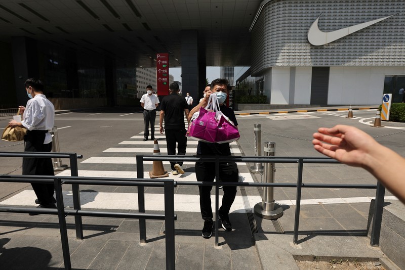 Residents wearing masks visit Yu Garden Mall, Thursday, June 2, 2022, in Shanghai. Traffic, pedestrians and joggers reappeared on the streets of Shanghai on Wednesday as China's largest city began returning to normalcy amid the easing of a strict two-month COVID-19 lockdown that has drawn unusual protests over its heavy-handed implementation. (AP Photo/Ng Han Guan)