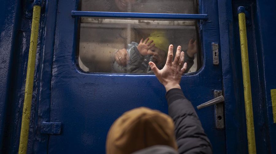 Stanislav says goodbye to his two-year-old son David and wife Anna after they boarded a train that will take them to Lviv, from the station in Kyiv, Ukraine, Thursday, March 3. 2022. Stanislav stayed to fight as his family sought refuge in a neighboring country. (AP Photo/Emilio Morenatti)