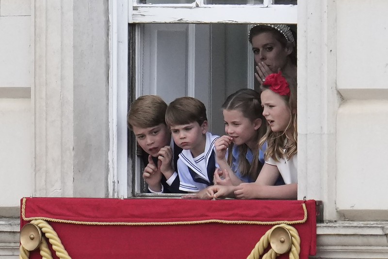 Members of the public fill The Mall ahead of a flypast over Buckingham Palace, during the Trooping the Color in London, Thursday, June 2, 2022, on the first of four days of celebrations to mark the Platinum Jubilee. The events over a long holiday weekend in the U.K. are meant to celebrate the monarch's 70 years of service. (Paul Ellis/Pool Photo via AP)