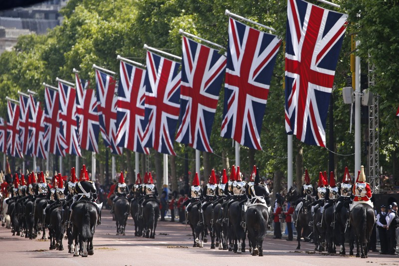 Members of the public fill The Mall ahead of a flypast over Buckingham Palace, during the Trooping the Color in London, Thursday, June 2, 2022, on the first of four days of celebrations to mark the Platinum Jubilee. The events over a long holiday weekend in the U.K. are meant to celebrate the monarch's 70 years of service. (Paul Ellis/Pool Photo via AP)