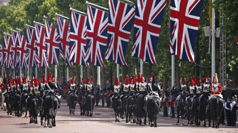 Members of the public fill The Mall ahead of a flypast over Buckingham Palace, during the Trooping the Color in London, Thursday, June 2, 2022, on the first of four days of celebrations to mark the Platinum Jubilee. The events over a long holiday weekend in the U.K. are meant to celebrate the monarch's 70 years of service. (Paul Ellis/Pool Photo via AP)