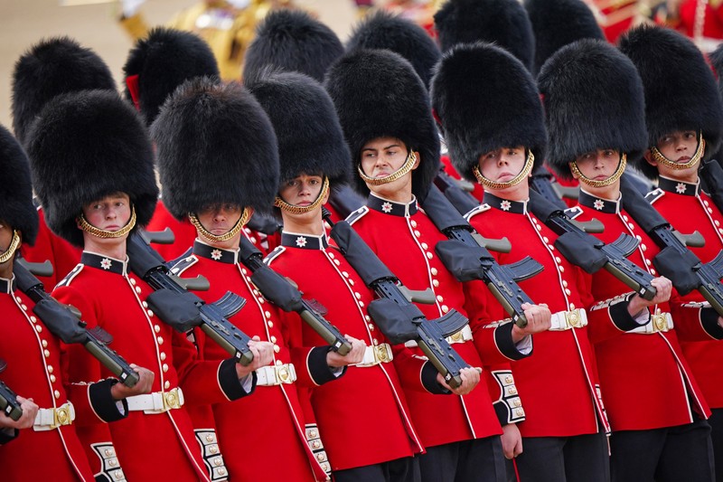 Members of the public fill The Mall ahead of a flypast over Buckingham Palace, during the Trooping the Color in London, Thursday, June 2, 2022, on the first of four days of celebrations to mark the Platinum Jubilee. The events over a long holiday weekend in the U.K. are meant to celebrate the monarch's 70 years of service. (Paul Ellis/Pool Photo via AP)