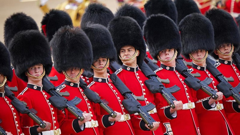 Members of the public fill The Mall ahead of a flypast over Buckingham Palace, during the Trooping the Color in London, Thursday, June 2, 2022, on the first of four days of celebrations to mark the Platinum Jubilee. The events over a long holiday weekend in the U.K. are meant to celebrate the monarch's 70 years of service. (Paul Ellis/Pool Photo via AP)