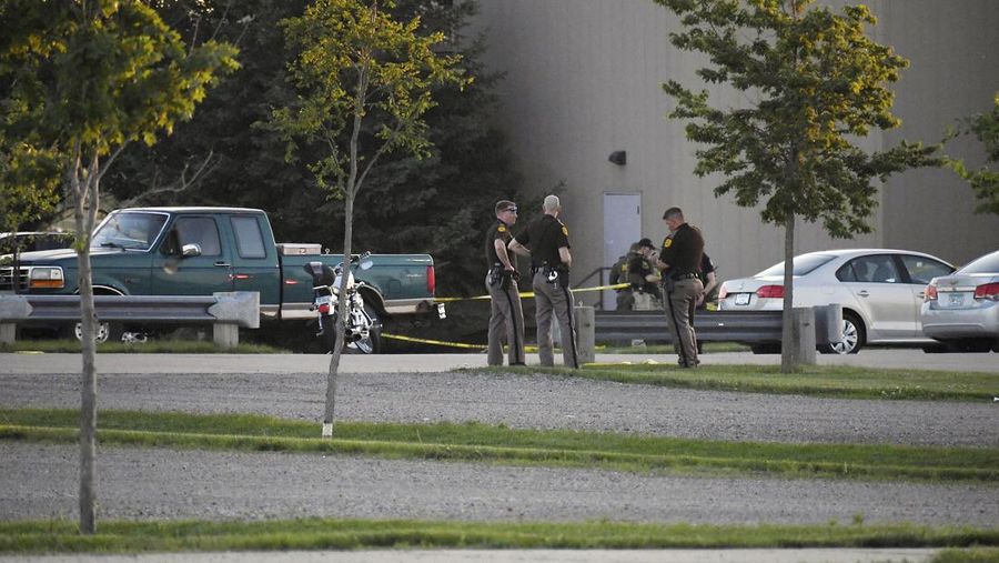 Troopers from the Iowa State Patrol stand outside Cornerstone Church after a shooting on Thursday, June 2, 2022 in Ames, Iowa. Two people and a shooter died Thursday night in a shooting outside a church in Ames, authorities said. (Nirmalendu Majumdar/The Des Moines Register via AP)
