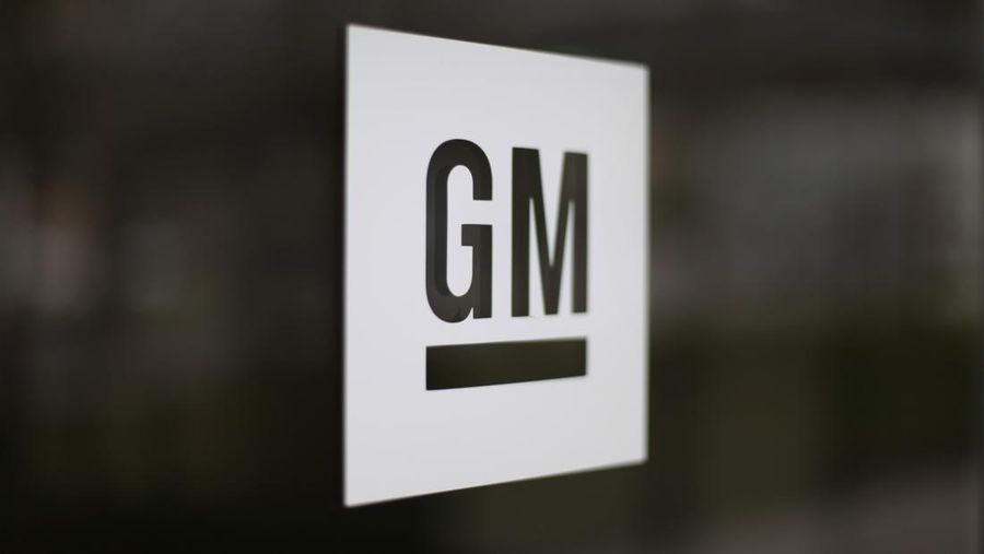 FILE - This Friday, May 16, 2014, file photo, shows the General Motors logo at the company's world headquarters in Detroit.  General Motors says it is making the first mass-production autonomous car without a steering wheel or pedals. The company says it has filed a petition with the federal government seeking permission to put the vehicles on the road sometime next year with no human backup drivers. GM’s Cruise Automation unit has announced plans to carry passengers in self-driving cars that won’t have a backup driver in 2019. (AP Photo/Paul Sancya, File)