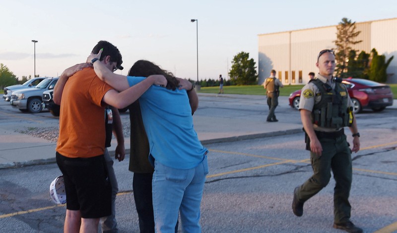 Troopers from the Iowa State Patrol stand outside Cornerstone Church after a shooting on Thursday, June 2, 2022 in Ames, Iowa. Two people and a shooter died Thursday night in a shooting outside a church in Ames, authorities said. (Nirmalendu Majumdar/The Des Moines Register via AP)