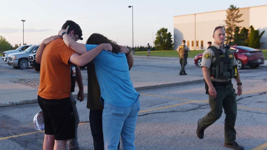 Troopers from the Iowa State Patrol stand outside Cornerstone Church after a shooting on Thursday, June 2, 2022 in Ames, Iowa. Two people and a shooter died Thursday night in a shooting outside a church in Ames, authorities said. (Nirmalendu Majumdar/The Des Moines Register via AP)