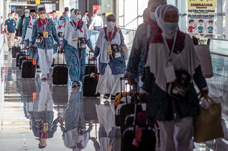 Jemaah haji Indonesia bersiap berangkat dari Bandara Internasional Juanda Surabaya pada 4 Juni 2022 untuk pertama kalinya sejak absennya ibadah haji ke Mekkah di Arab Saudi selama beberapa tahun di tengah pandemi virus corona Covid-19. (AFP/JUNI KRISWANTO) Jemaah haji Indonesia bersiap berangkat dari Bandara Internasional Juanda Surabaya pada 4 Juni 2022 untuk pertama kalinya sejak absennya ibadah haji ke Mekkah di Arab Saudi selama beberapa tahun di tengah pandemi virus corona Covid-19. (AFP/JUNI KRISWANTO)