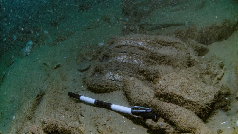 Brothers Julian Barnwell and Lincoln Barnwell measure a cannon underwater, from the shipwreck of HMS Gloucester, which sank 340 years ago while carrying King of England, James Stuart, and was discovered off the coast of Norfolk, Britain July 25, 2018. Norfolk Historic Shipwrecks/Handout via REUTERS    THIS IMAGE HAS BEEN SUPPLIED BY A THIRD PARTY. NO RESALES. NO ARCHIVES. MANDATORY CREDIT.