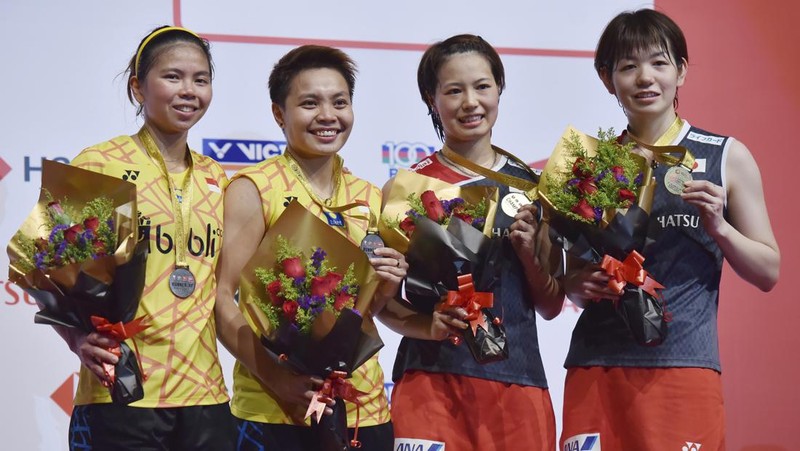 Indonesia's Greysia Polii, right, carries the Indonesian flag after defeating Germany's Brigit Overzier and Kathrin Piotrowski during their semi-final of the Uber Cup badminton championship match at Istora Senayan stadium in Jakarta, Indonesia, Thursday, May 15, 2008. (AP Photo/Firdia Lisnawati)