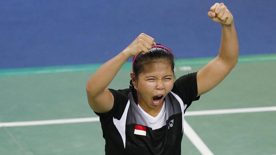 Indonesia's Greysia Polii, right, carries the Indonesian flag after defeating Germany's Brigit Overzier and Kathrin Piotrowski during their semi-final of the Uber Cup badminton championship match at Istora Senayan stadium in Jakarta, Indonesia, Thursday, May 15, 2008. (AP Photo/Firdia Lisnawati)