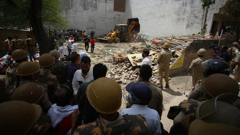 Sebuah buldoser menghancurkan rumah seorang pria Muslim yang dituduh otoritas negara bagian Uttar Pradesh terlibat dalam kerusuhan pekan lalu, yang meletus menyusul komentar tentang Nabi Muhammad oleh anggota Partai Bharatiya Janata (BJP) yang berkuasa di India, di Prayagraj, India, Minggu (12/6/2022). Pihak berwenang mengklaim rumah itu dibangun secara ilegal. (REUTERS/Ritesh Shukla)