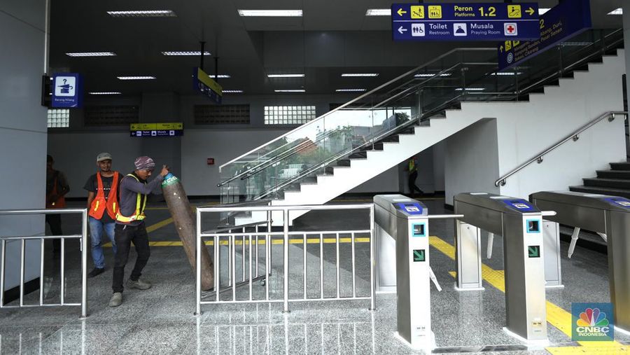 Pekerja membersihkan papan nama Stasiun Matraman di Jakarta, Senin (13/6/2022). PT Kereta Commuter Indonesia (KCI) menyatakan Stasiun Matraman segera beroperasi sebagai alternatif shelter (CNBC Indonesia/ Tri Susilo)