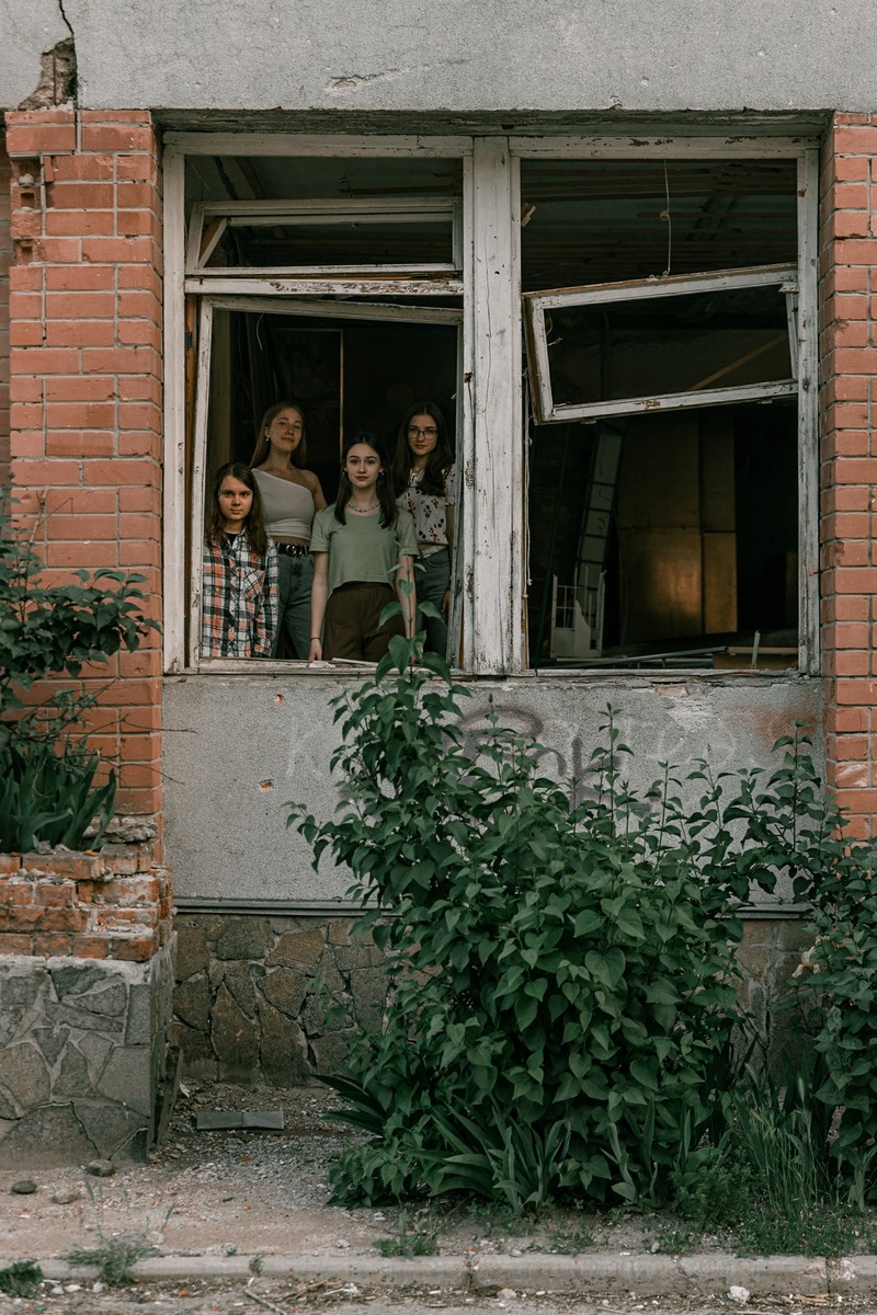 UKRAINE-CRISIS/GRADUATION-ALBUM Students pose in front of a destroyed military vehicle for a high school graduation photoshoot, as Russia's attack on Ukraine continues, in Chernihiv, Ukraine, June 5, 2022. Picture taken on June 5, 2022. Instagram/@senykstas/Handout via REUTERS THIS IMAGE HAS BEEN SUPPLIED BY A THIRD PARTY. MANDATORY CREDIT. NO RESALES. NO ARCHIVES.