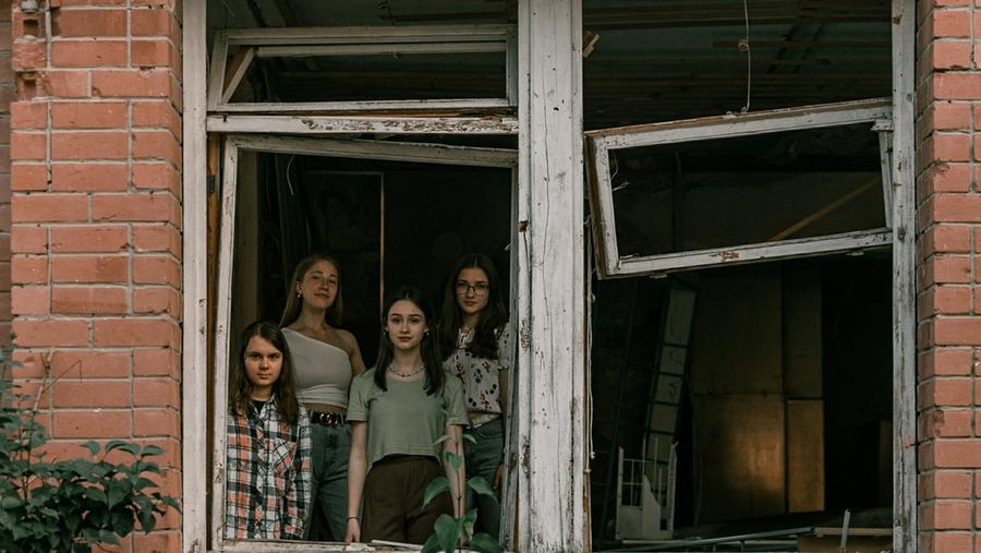 Students pose in front of a destroyed military vehicle for a high school graduation photoshoot, as Russia's attack on Ukraine continues, in Chernihiv, Ukraine, June 5, 2022. Picture taken on June 5, 2022. Instagram/@senykstas/Handout via REUTERS  THIS IMAGE HAS BEEN SUPPLIED BY A THIRD PARTY. MANDATORY CREDIT. NO RESALES. NO ARCHIVES.