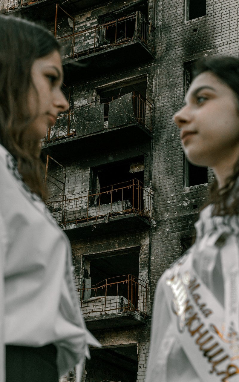 Students pose in front of a destroyed military vehicle for a high school graduation photoshoot, as Russia's attack on Ukraine continues, in Chernihiv, Ukraine, June 5, 2022. Picture taken on June 5, 2022. Instagram/@senykstas/Handout via REUTERS  THIS IMAGE HAS BEEN SUPPLIED BY A THIRD PARTY. MANDATORY CREDIT. NO RESALES. NO ARCHIVES.
