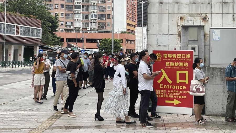MACAO, CHINA - JUNE 19: People queue up for COVID-19 nucleic acid tests on June 19, 2022 in Macao, China. (Photo by VCG/VCG via Getty Images)
