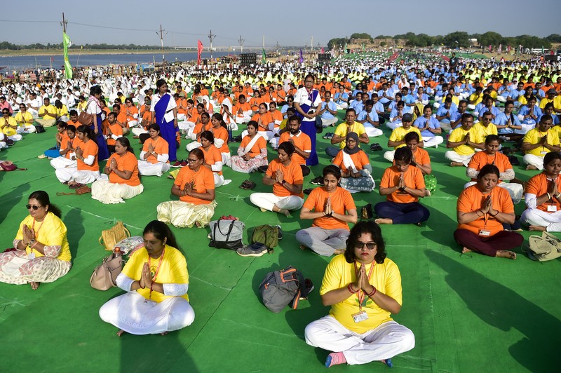 India's Prime Minister Narendra Modi (C) performs yoga with others to celebrate the International Day of Yoga in front of the Mysore Palace in Mysore on June 21, 2022. (Photo by Manjunath Kiran / AFP) (Photo by MANJUNATH KIRAN/AFP via Getty Images)