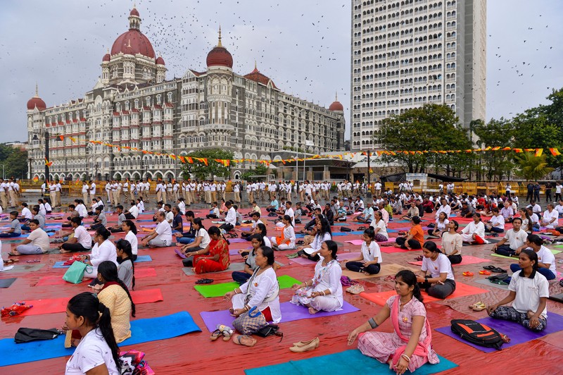 India's Prime Minister Narendra Modi (C) performs yoga with others to celebrate the International Day of Yoga in front of the Mysore Palace in Mysore on June 21, 2022. (Photo by Manjunath Kiran / AFP) (Photo by MANJUNATH KIRAN/AFP via Getty Images)