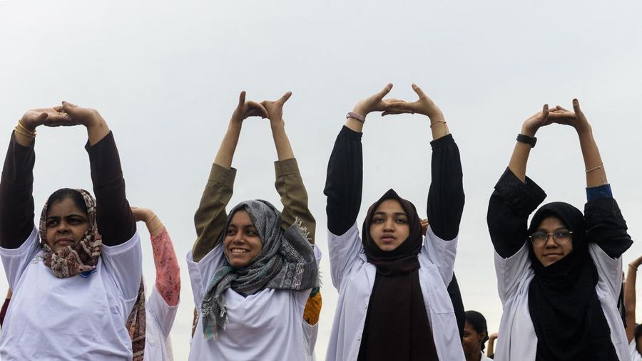 India's Prime Minister Narendra Modi (C) performs yoga with others to celebrate the International Day of Yoga in front of the Mysore Palace in Mysore on June 21, 2022. (Photo by Manjunath Kiran / AFP) (Photo by MANJUNATH KIRAN/AFP via Getty Images)