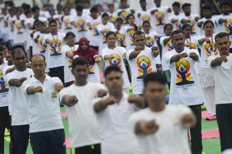 India's Prime Minister Narendra Modi (C) performs yoga with others to celebrate the International Day of Yoga in front of the Mysore Palace in Mysore on June 21, 2022. (Photo by Manjunath Kiran / AFP) (Photo by MANJUNATH KIRAN/AFP via Getty Images)