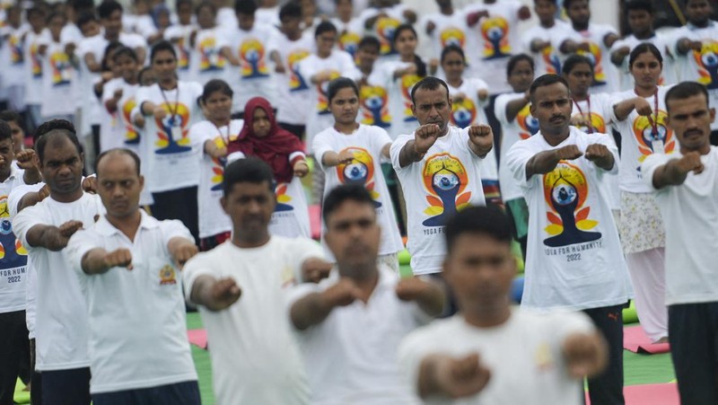 India's Prime Minister Narendra Modi (C) performs yoga with others to celebrate the International Day of Yoga in front of the Mysore Palace in Mysore on June 21, 2022. (Photo by Manjunath Kiran / AFP) (Photo by MANJUNATH KIRAN/AFP via Getty Images)