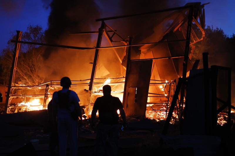 DRUZHKIVKA, UKRAINE - JUNE 20: Flames rise from a structure after it was hit by a projectile on June 20, 2022 in Druzhkivka, Ukraine. In recent weeks, Russia has concentrated its firepower on Ukraine's Donbas region, where it has long backed two separatist regions at war with the Ukrainian government since 2014. (Photo by Scott Olson/Getty Images)(Photo by Scott Olson/Getty Images)