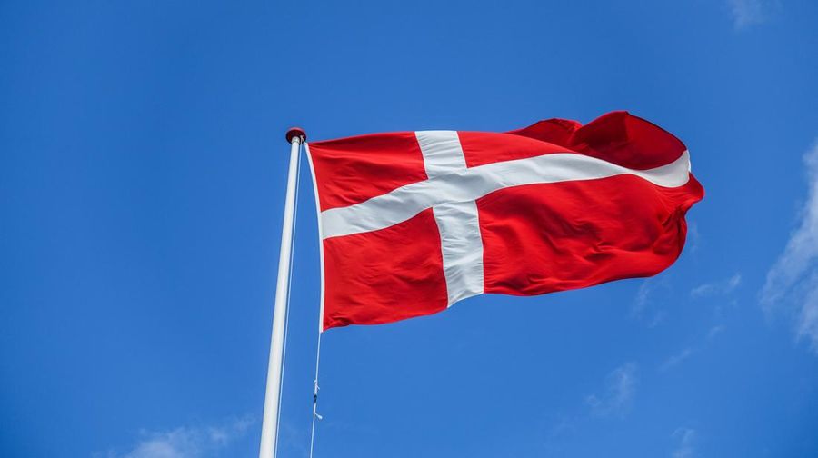 Danish flag on the wind is seen during the cold, rainy but bit sunny summer day on Toro Island, Toro huse, Fyn (Funen), Denmark on 1 August 2021 (Photo by Michal Fludra/NurPhoto via Getty Images)