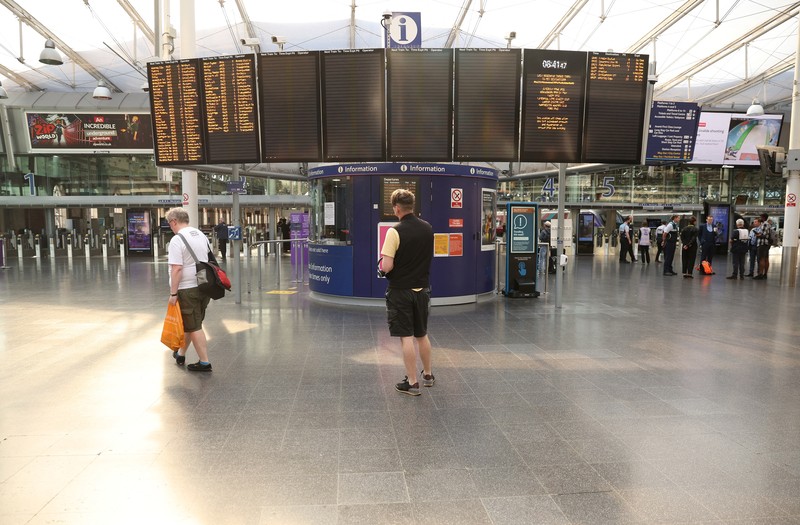 1241429779 Pamphlets and newspapers are distributed at a picket line outside Waterloo Station in London on June 21, 2022 as the biggest rail strike in over 30 years hits the UK. - Rush-hour commuters in the UK faced chaos as railway workers began the network's biggest strike action in more than three decades, with a cost-of-living crisis threatening wider industrial action. (Photo by Ben Stansall / AFP) (Photo by BEN STANSALL/AFP via Getty Images)