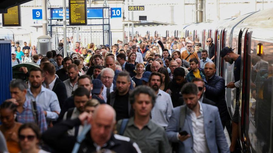 Passengers walk after getting off a train at the Waterloo Station, on the first day of national rail strike in London, Britain, June 21, 2022. REUTERS/Henry Nicholls