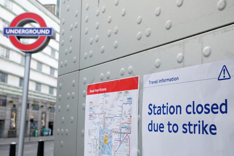 Pamphlets and newspapers are distributed at a picket line outside Waterloo Station in London on June 21, 2022 as the biggest rail strike in over 30 years hits the UK. - Rush-hour commuters in the UK faced chaos as railway workers began the network's biggest strike action in more than three decades, with a cost-of-living crisis threatening wider industrial action. (Photo by Ben Stansall / AFP) (Photo by BEN STANSALL/AFP via Getty Images)