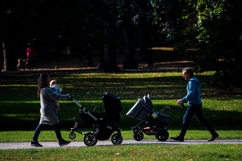 Two men take care of their babies at Humlegarden in Stockholm on September 24, 2020. - While France has just increased paternity leave to 28 days, in Sweden, a pioneer in gender equality, parents share 480 days off, which can be taken until the child's 12th birthday at 80% of the salary for the first 390 days and fathers have a minimum of three months, but only half of them take full advantage of it. (Photo by Jonathan NACKSTRAND / AFP) (Photo by JONATHAN NACKSTRAND/AFP via Getty Images)