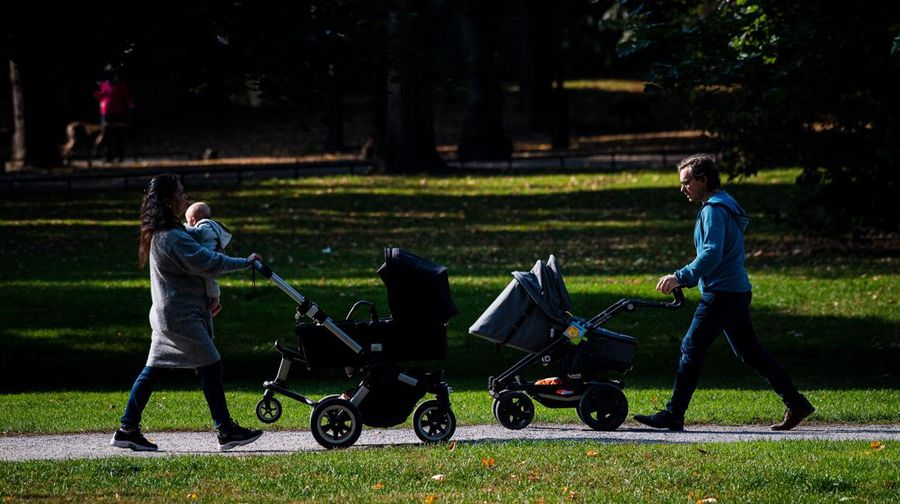 Two men take care of their babies at Humlegarden in Stockholm on September 24, 2020. - While France has just increased paternity leave to 28 days, in Sweden, a pioneer in gender equality, parents share 480 days off, which can be taken until the child's 12th birthday at 80% of the salary for the first 390 days and fathers have a minimum of three months, but only half of them take full advantage of it. (Photo by Jonathan NACKSTRAND / AFP) (Photo by JONATHAN NACKSTRAND/AFP via Getty Images)