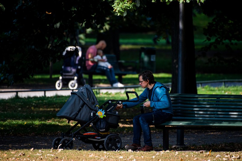 Two men take care of their babies at Humlegarden in Stockholm on September 24, 2020. - While France has just increased paternity leave to 28 days, in Sweden, a pioneer in gender equality, parents share 480 days off, which can be taken until the child's 12th birthday at 80% of the salary for the first 390 days and fathers have a minimum of three months, but only half of them take full advantage of it. (Photo by Jonathan NACKSTRAND / AFP) (Photo by JONATHAN NACKSTRAND/AFP via Getty Images)