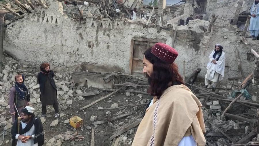 In this photo released by a set-run news agency Bakhtar, Afghans look at destruction caused by an earthquake in the province of Paktika, eastern Afghanistan, Wednesday, June 22, 2022. (Bakhtar News Agency via AP)