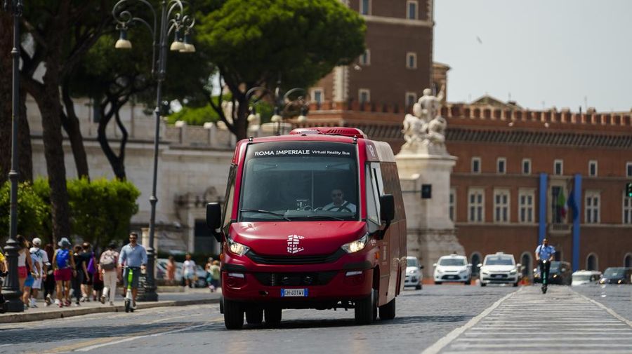 Journalists participating in the first tour of the Imperial Rome - Virtual Reality Bus look at 3D VR images of ancient Rome during the project presentation to the media in downtown Rome, Tuesday, June 21, 2022. The virtual tour of ancient Rome, includes the Roman Forum, the Colosseum, the Palatine Hill, the Circus Maximus, and the Theater of Marcellus, in a 3D immersion with special 
