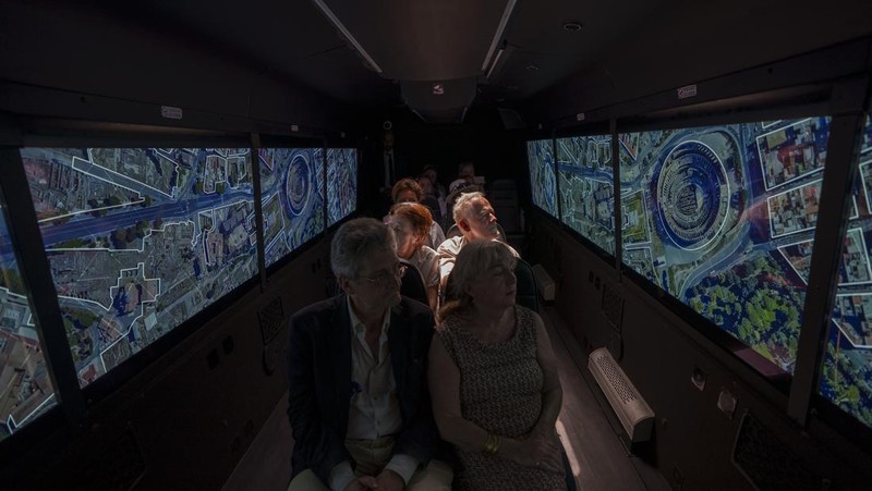 Journalists participating in the first tour of the Imperial Rome - Virtual Reality Bus look at 3D VR images of ancient Rome during the project presentation to the media in downtown Rome, Tuesday, June 21, 2022. The virtual tour of ancient Rome, includes the Roman Forum, the Colosseum, the Palatine Hill, the Circus Maximus, and the Theater of Marcellus, in a 3D immersion with special 