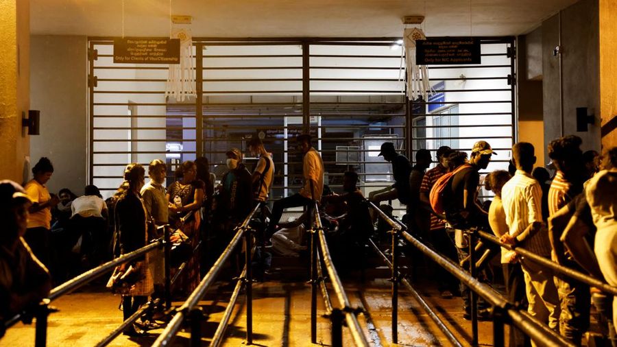 People wait to collect their passports at the Sri Lanka's Immigration and Emigration Department, amid the country's economic crisis, in Colombo, Sri Lanka, June 8, 2022. Picture taken June 8,2022.  REUTERS/Dinuka Liyanawatte