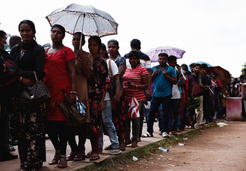 People wait to collect their passports at the Sri Lanka's Immigration and Emigration Department, amid the country's economic crisis, in Colombo, Sri Lanka, June 8, 2022. Picture taken June 8,2022.  REUTERS/Dinuka Liyanawatte
