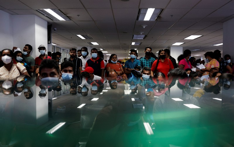SRI LANKA-CRISIS/EMIGRATION People wait to collect their passports at the Sri Lanka's Immigration and Emigration Department, amid the country's economic crisis, in Colombo, Sri Lanka, June 8, 2022. Picture taken June 8,2022. REUTERS/Dinuka Liyanawatte