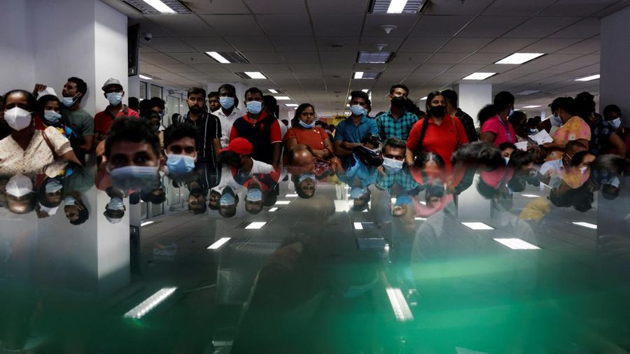 People wait to collect their passports at the Sri Lanka's Immigration and Emigration Department, amid the country's economic crisis, in Colombo, Sri Lanka, June 8, 2022. Picture taken June 8,2022.  REUTERS/Dinuka Liyanawatte