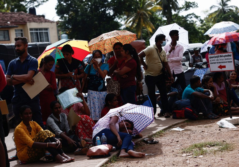 People wait to collect their passports at the Sri Lanka's Immigration and Emigration Department, amid the country's economic crisis, in Colombo, Sri Lanka, June 8, 2022. Picture taken June 8,2022.  REUTERS/Dinuka Liyanawatte