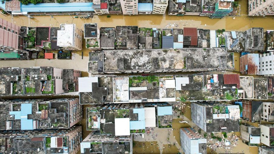 QINGYUAN, CHINA - JUNE 22: Aerial view of residential houses surrounded by flood water after torrential rains on June 22, 2022 in Qingyuan, Guangdong Province of China. Flood control authority of China's Guangdong Province activated a Level-I emergency response on Tuesday. (Photo by VCG/VCG via Getty Images)