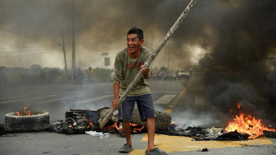 A protester throws a tear gas canister fired by security personnel after Ecuador's armed forces warned they would not allow ongoing protests against President Guillermo Lasso's economic policies to damage the country's democracy, in Quito, Ecuador June 21, 2022. REUTERS/Santiago Arcos