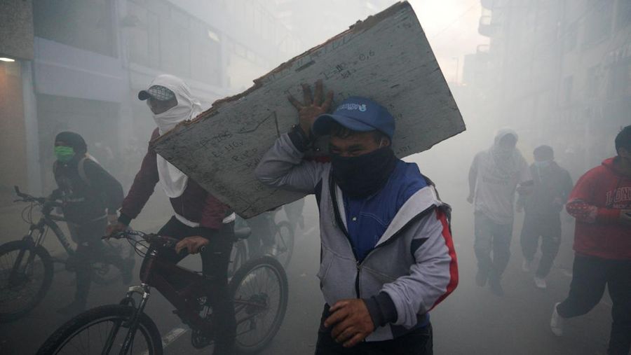 A protester throws a tear gas canister fired by security personnel after Ecuador's armed forces warned they would not allow ongoing protests against President Guillermo Lasso's economic policies to damage the country's democracy, in Quito, Ecuador June 21, 2022. REUTERS/Santiago Arcos