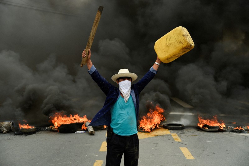 A protester throws a tear gas canister fired by security personnel after Ecuador's armed forces warned they would not allow ongoing protests against President Guillermo Lasso's economic policies to damage the country's democracy, in Quito, Ecuador June 21, 2022. REUTERS/Santiago Arcos